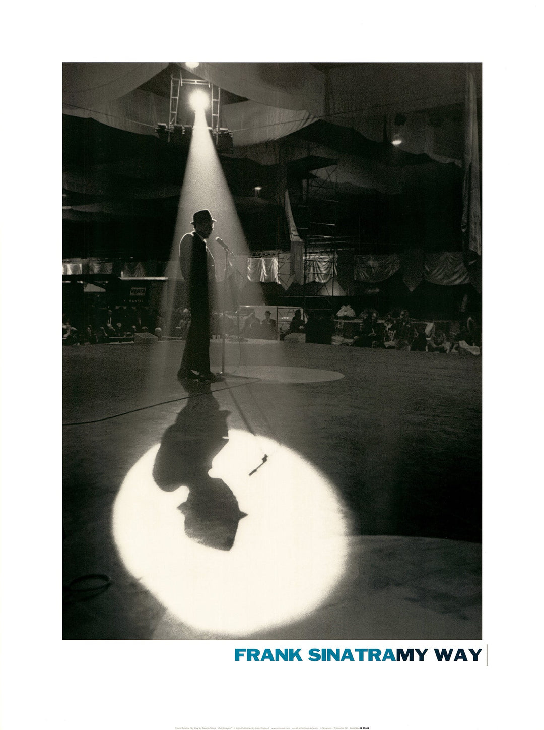 A silhouette of Frank Sinatra on a stage. A spotlight shines down on him, his shadow surrounded by a halo of light.