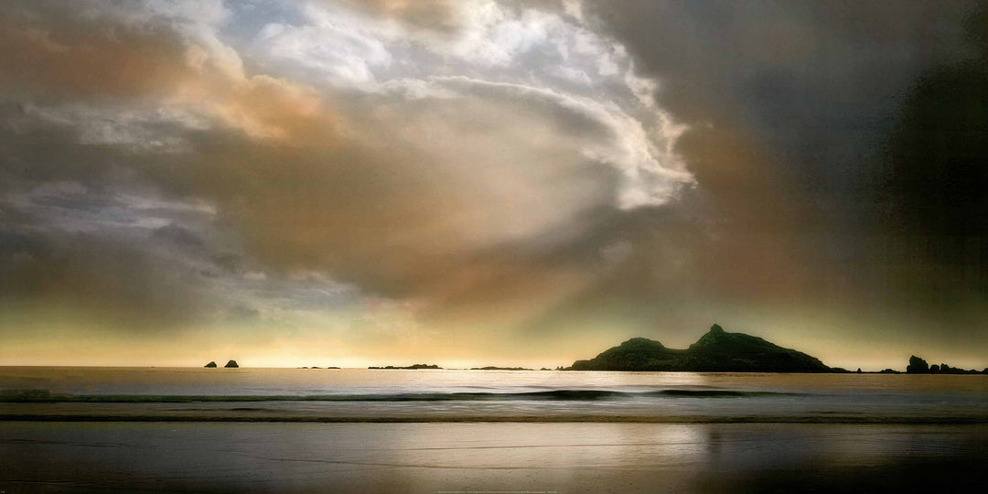 A beautiful sandy beach with amazing skies in the background.