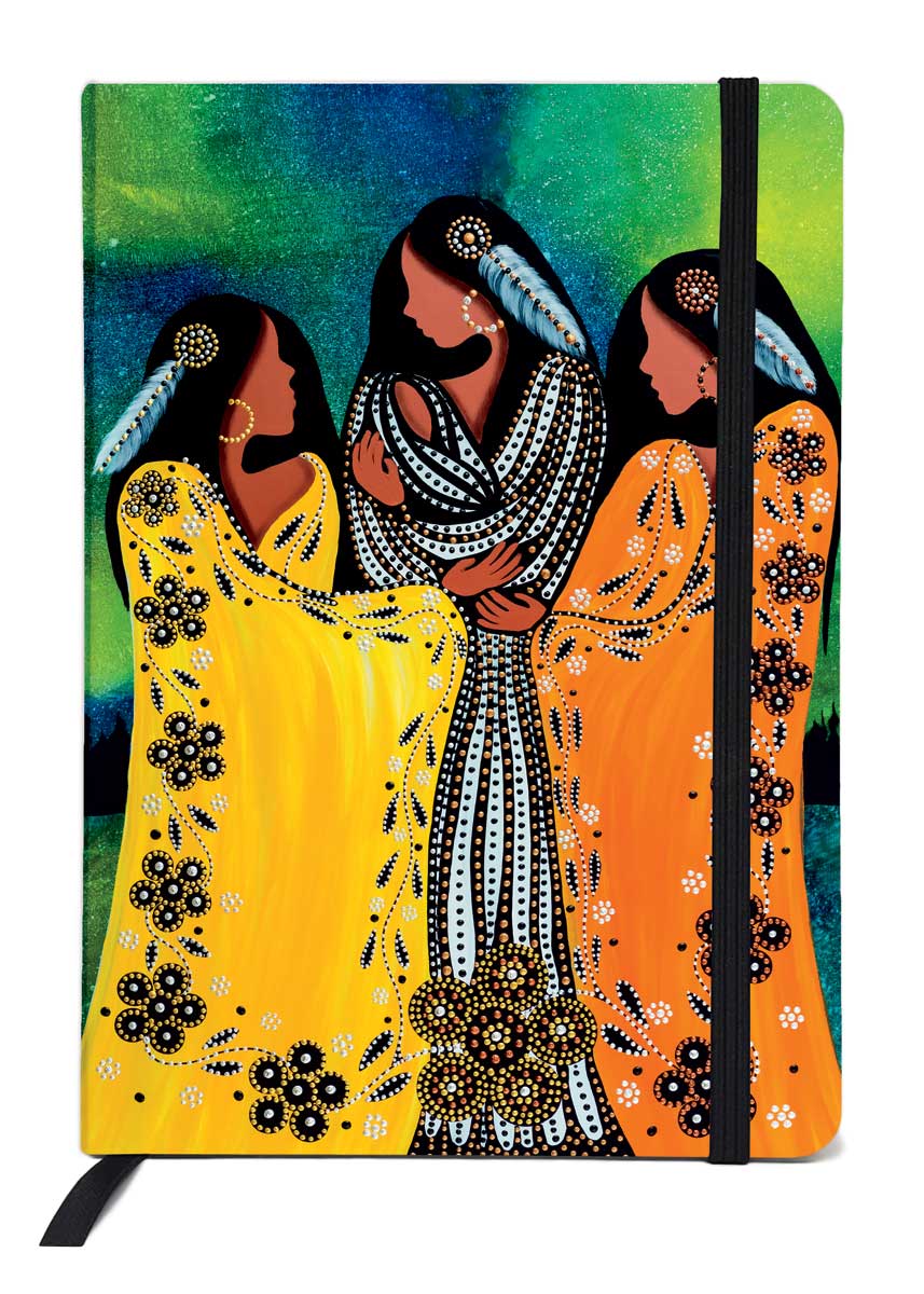 A woman in black and white holds a baby in her arms. Two women, one in orange and the other in yellow, embrace the woman. Printed on a journal.