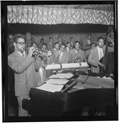Black and white portrait of Dizzy Gillespie, John Lewis, Cecil Payne, Miles Davis, and Ray Brown. They are playing at Downbeat, New York, N.Y. (1946).