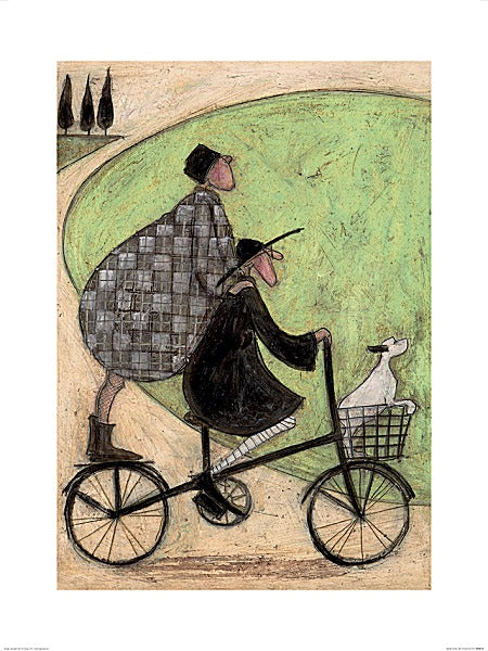 A man in a dark coat rides a bicycle. A round woman in a checkered coat stands on the back, her hands resting on his shoulders. Their white dog sits in the bike basket, their paws on the resting on the edge.