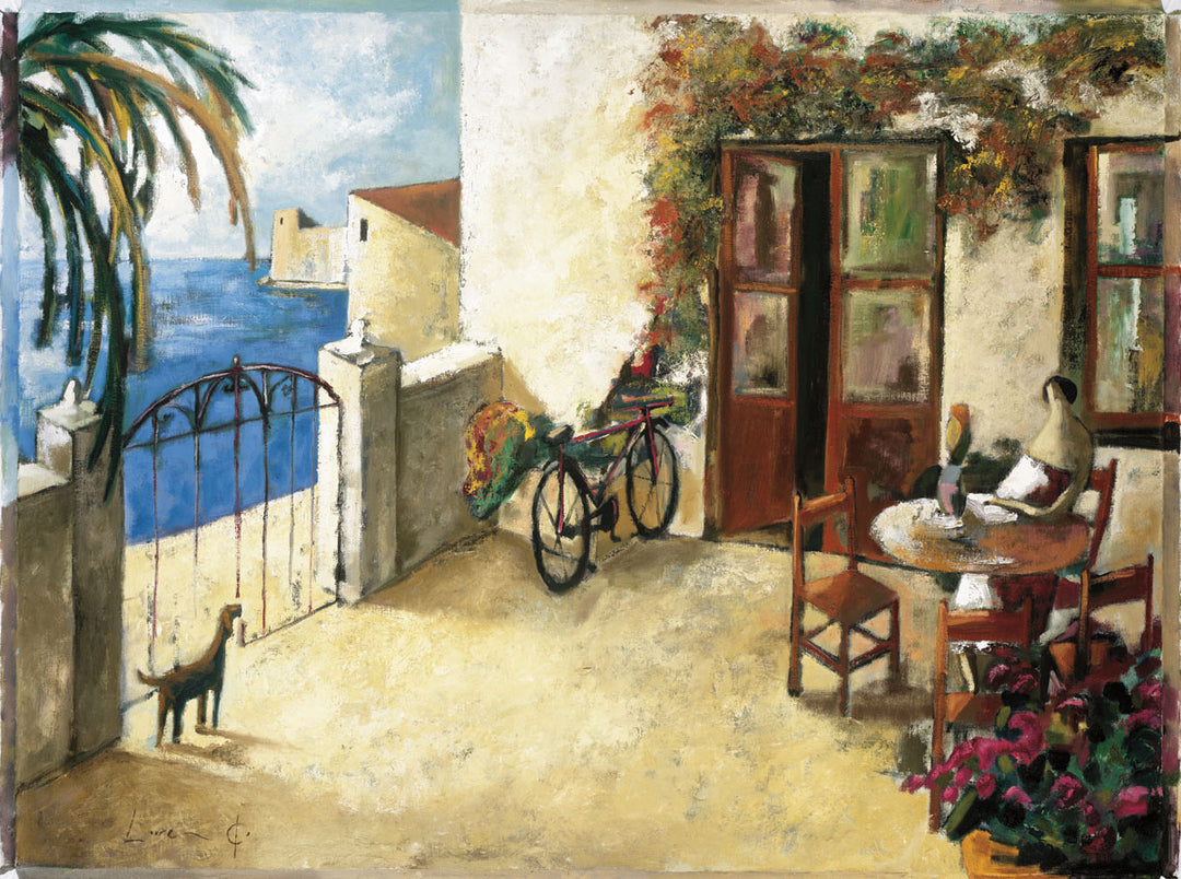 A sunny, seaside village. A woman sits at a table by a pair of doors. A bicycle rests near the short wall attached to the building. A dog stands by the gate of the wall, which overlooks the water.