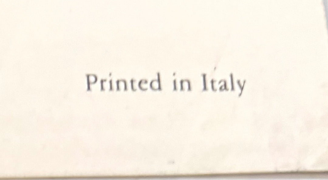 "Close-up of the words Printed in Italy in dark serif type on the cream lower margin of the print."