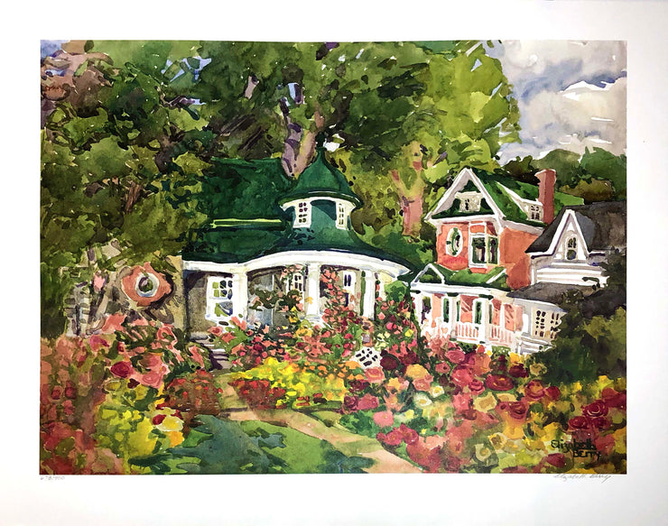 ﻿﻿Print of a watercolour. A green roofed cottage with white beams next to a red brick house. Red, yellow, and pink flowers cover the ground in front of the cottage. A large tree and its vibrant leaves stands behind the cottage.