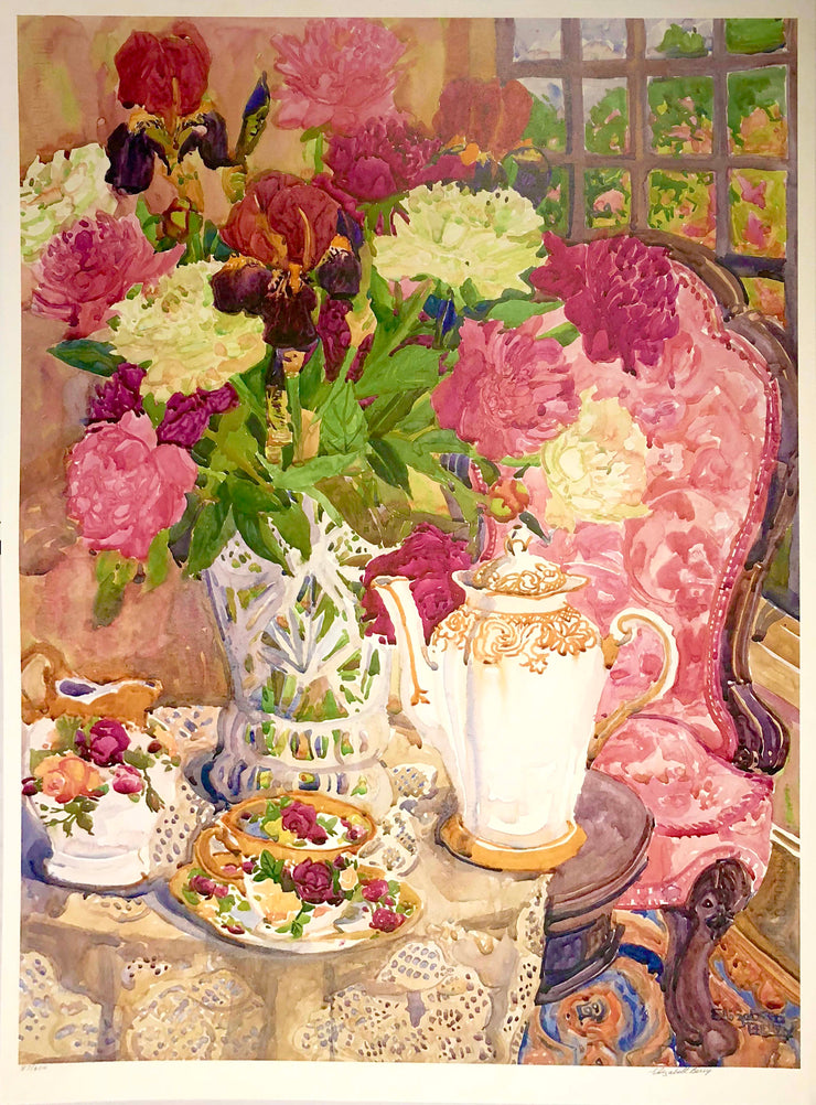 A watercolour print of an interior space. There is a circular table with lace covering it. On top of it is a tall vase with red, white, and pink flowers. Next to the vase is a tall, white teapot with yellow decals. There is also a teacup and saucer with gold and floral decals with a similar decorated pitcher. Behind the table is a wooden chair with pink cushions on the seat and back of the chair. A window in the background overlooks a green garden.