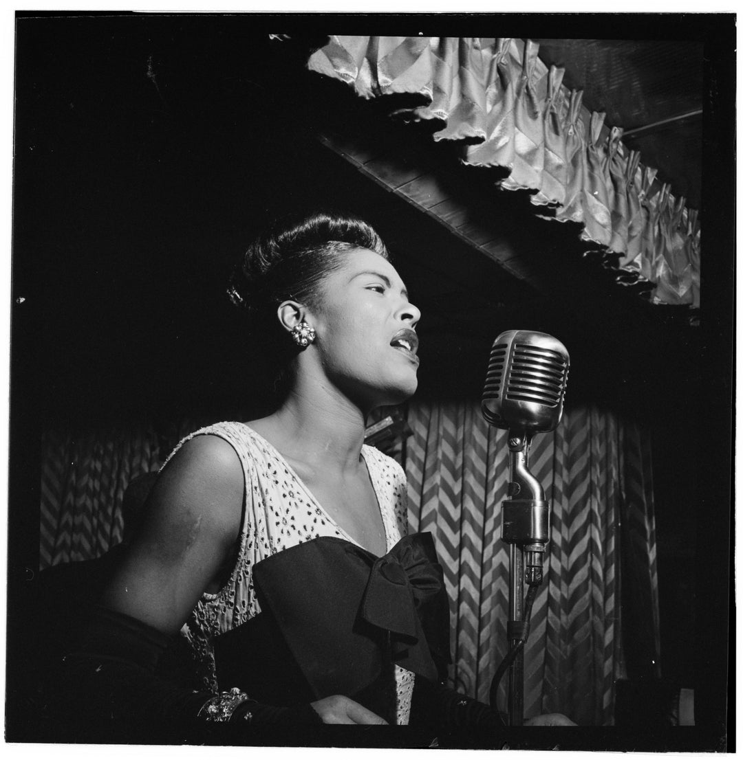 Black and white portrait of Billie Holiday singing at Downbeat, New York, N.Y. (1947)