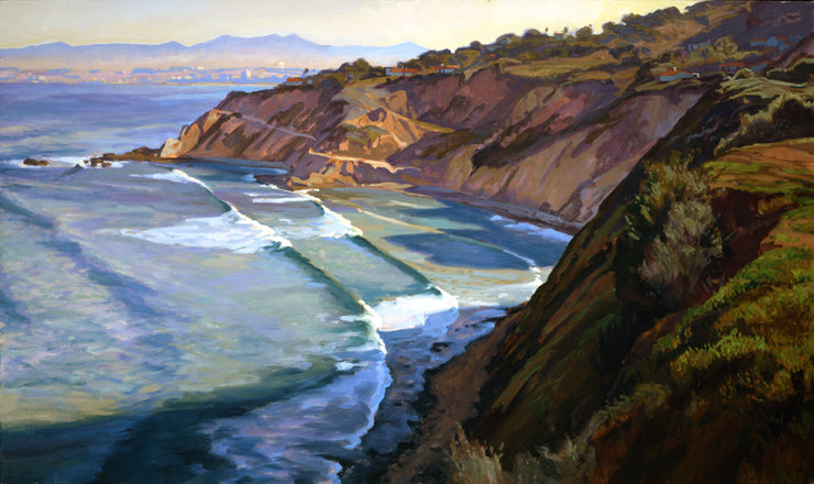 An oversize print of a cove with crashing waves. The cliffs tower above the water.