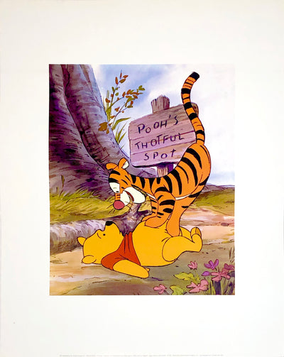 Tigger the tiger stands on Winnie the Pooh, the yellow bear's, belly, smiling down at him.
