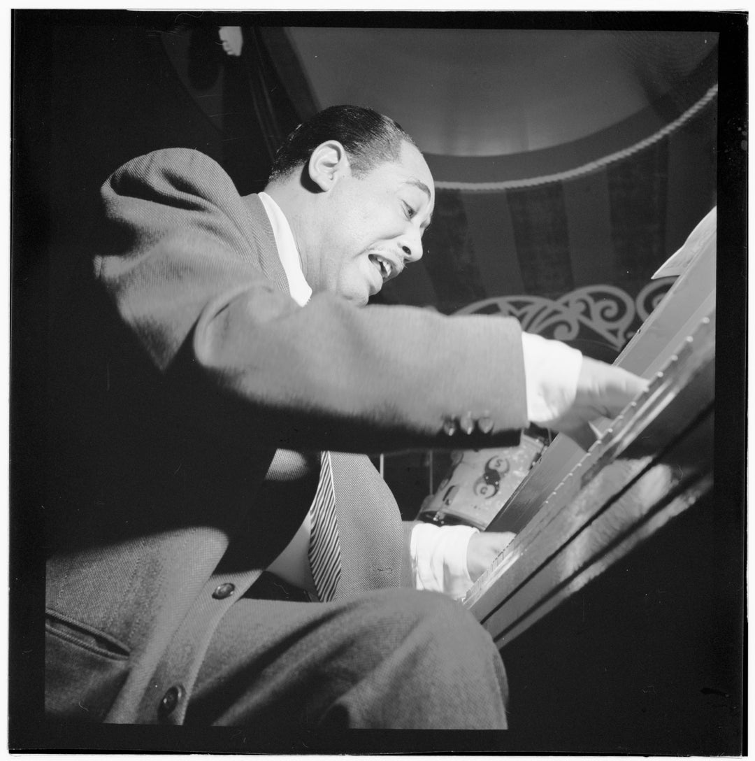 Black and white photograph of musician Duke Ellington playing the piano at Aquarium, New York, N.Y.