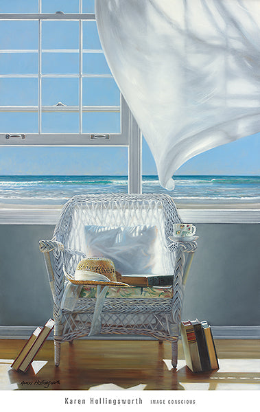 A white, wicker chair in a room. A hat, book, and pillow sit in the seat of the chair. Books on the floor rest on either side of the chair. A white curtain flaps in the wind by the open windows which look out onto waves rolling onto the shore. 