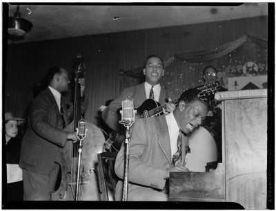 Black and white portrait of Wesley Prince, Oscar Moore, and Nat King Cole playing at Zanzibar, New York City, N.Y. (1946).