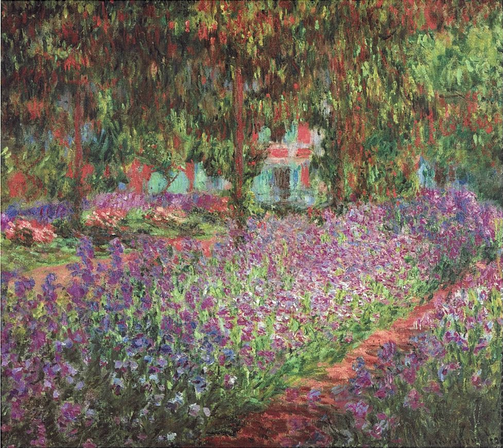 An impression of tall, purple flowers in a tree covered garden.
