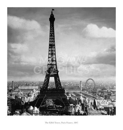 Text below image: The Eiffel Tower, Paris France, 1897  A black and white photo of the Eiffel Tower silhouetted against the Paris sky. A Ferris Wheel can be made out in the distance. The city fades into the distance.