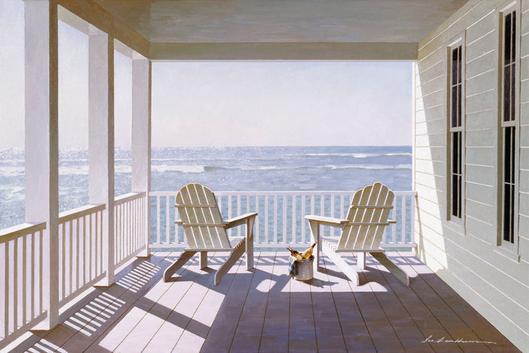 Two, white muskoka chairs sit on a covered porch with a white fence railing. The chairs overlook the sea, waves crashing along the water.