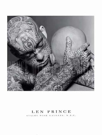 A black and white photograph of a tattooed person hugging the back of another bald person's head.