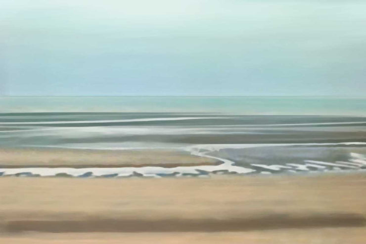 A landscape of a beach, waves washing ashore the sand gently. The sky is a teal haze above the calm water.