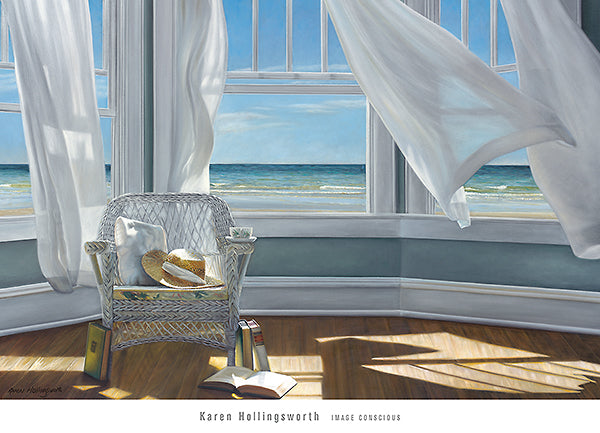 A room with three open windows overlooking a beach. Their white curtains billow. Inside, on a wood floor, is a white wicker chair. On the chair is a cushion, a sunhat with a white ribbon, and a teacup on its arm. At its base are several books, one of which lays open.